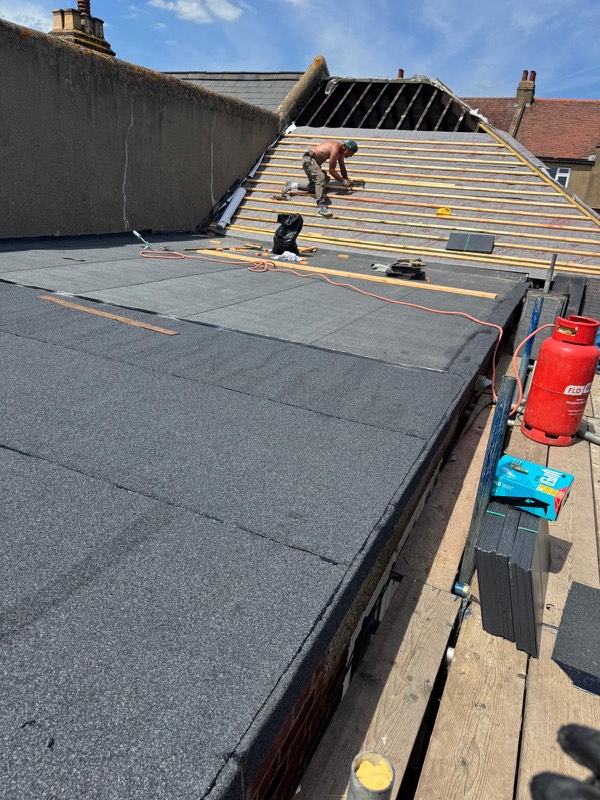 Re felting work in progress on a roof