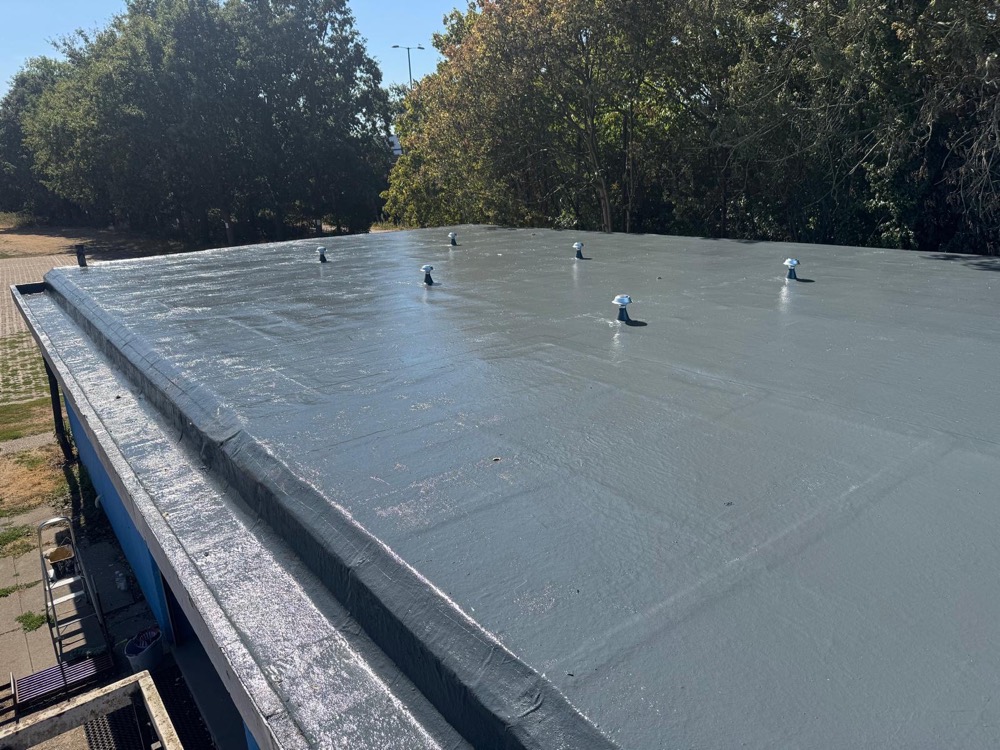 Flat roof with a liquid overlay waterproofing system, at a local sports centre